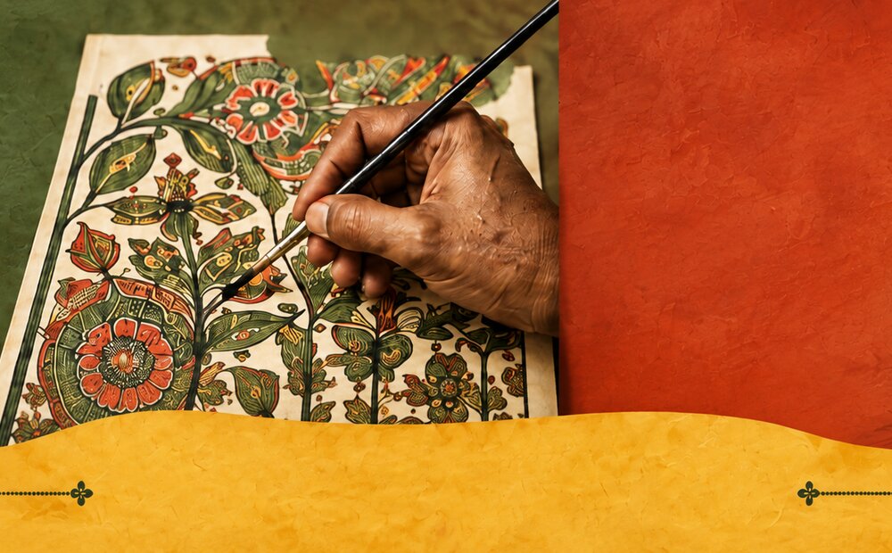 An artist's hand painting fine floral detail on a traditional artwork